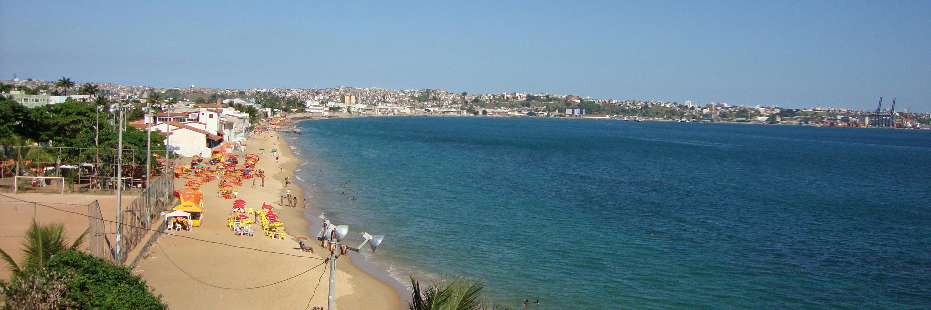 Sweeping shot of a coastline where people are enjoying the beach