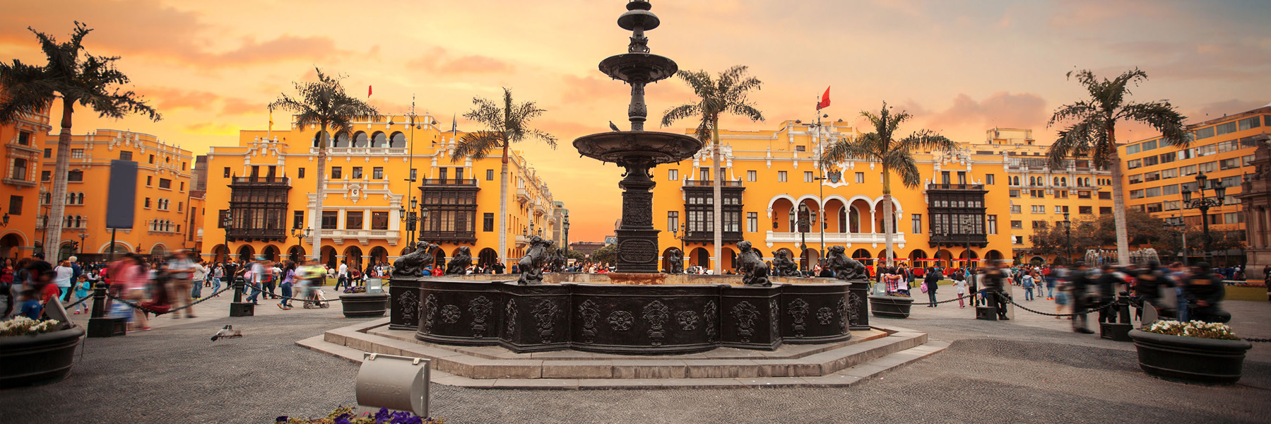 A fountain and bright yellow buildings in Lima, Peru 