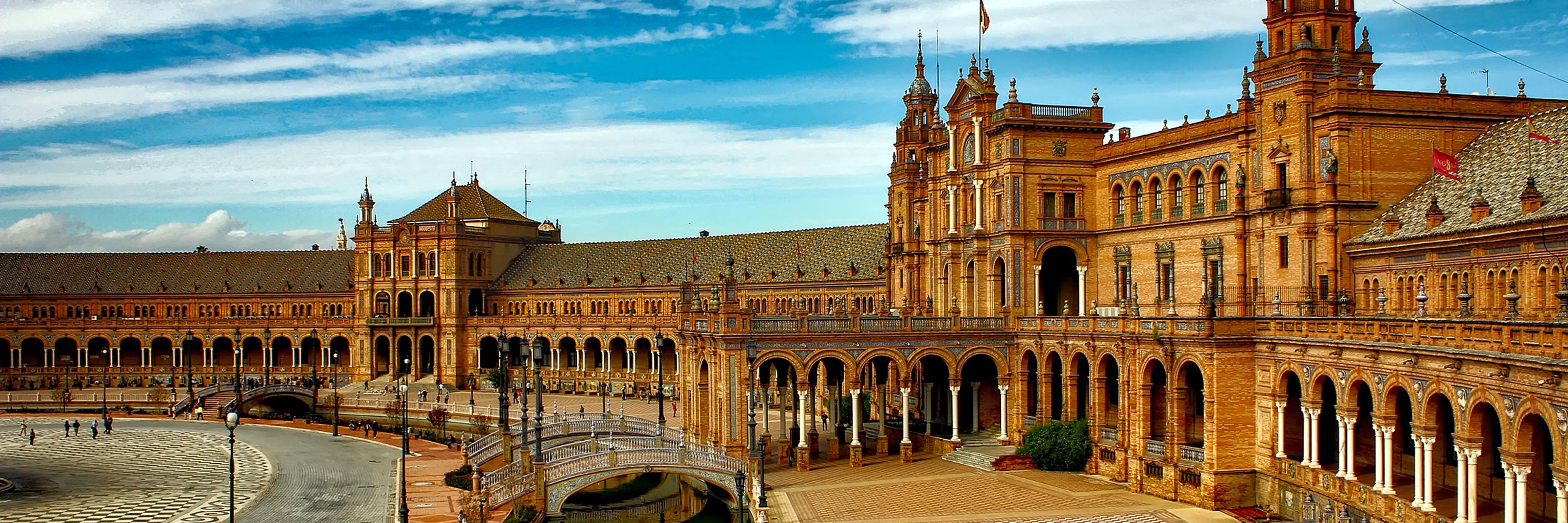 Large,ornate golden building in Seville, Spain 