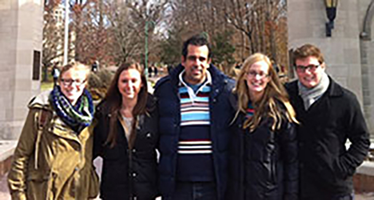 Four IU students gathered at Sample gates with Professor Herrera