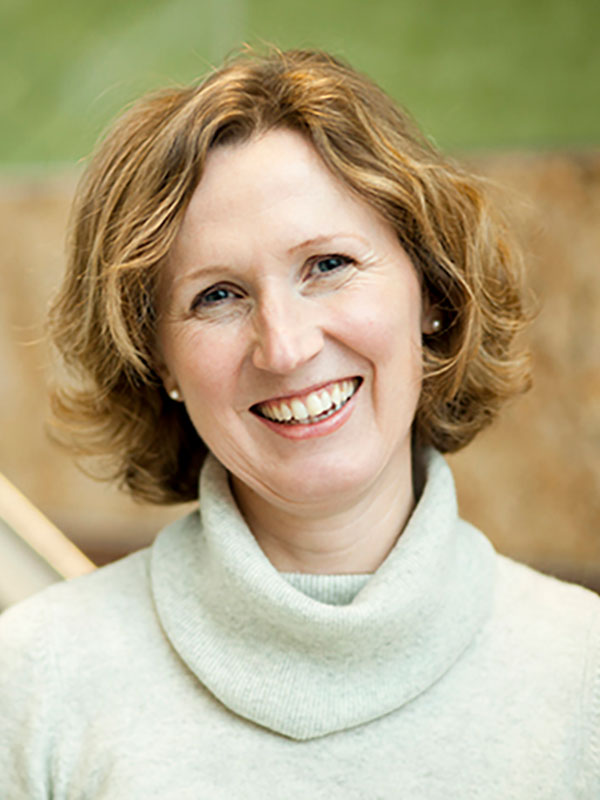 A headshot of Professor Anke Birkenmaier, who wears a white turtleneck sweater.