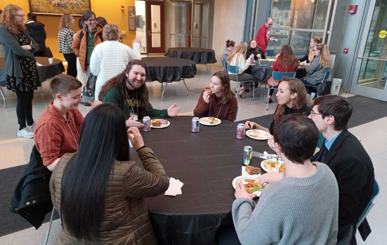 People eat at a table in the SGIS building.