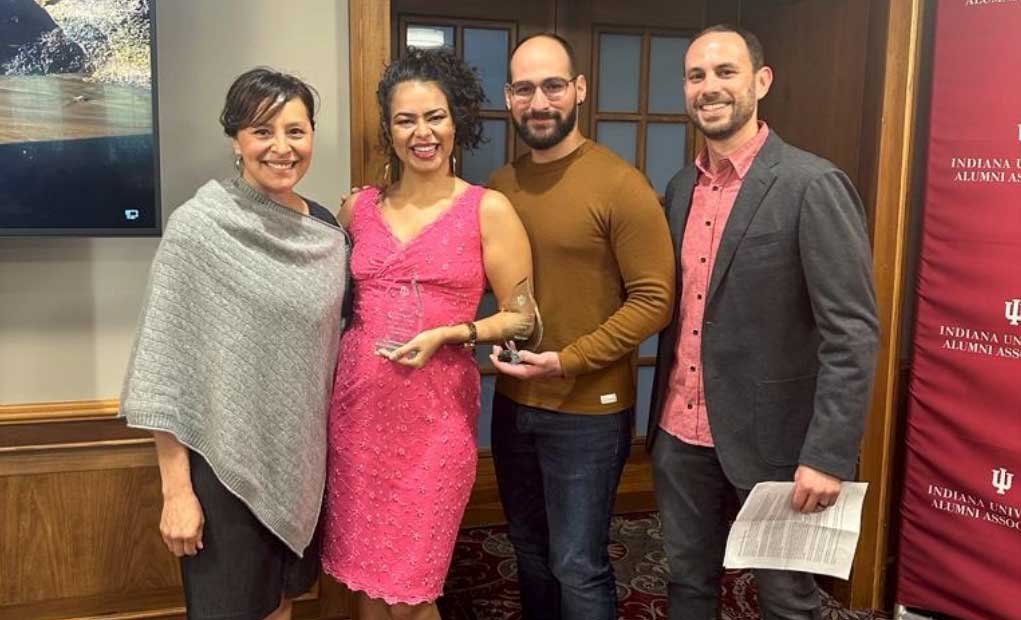 Four people pose in the Indiana Memorial Union.