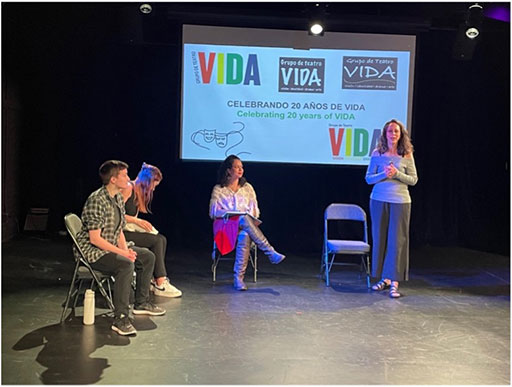 Four people on stage participating in a presentation celebrating 20 years of Grupo de Teatro VIDA.